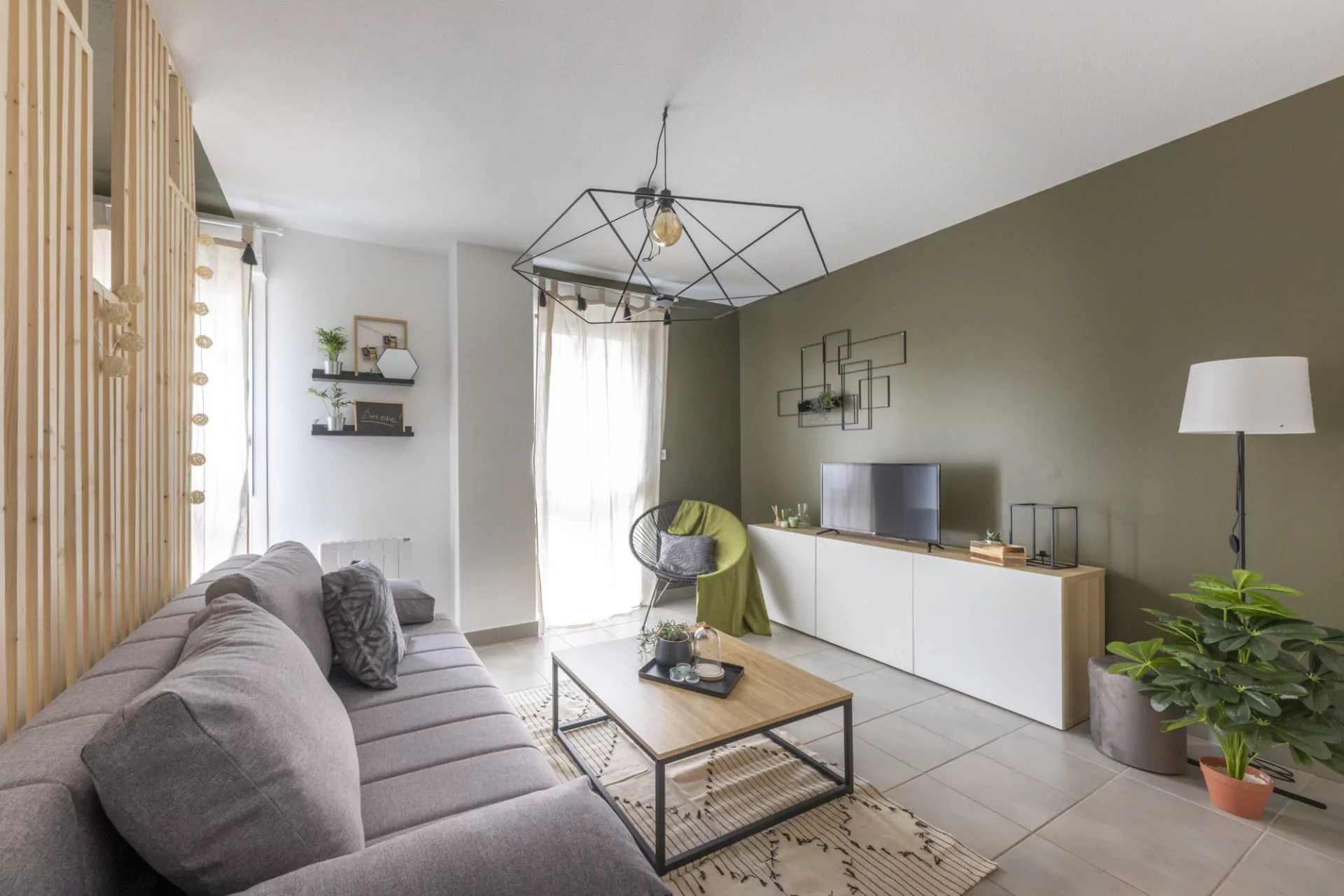 Séjour d'un appartement nantais rénové et meublé, avec claustra bois sur mesure